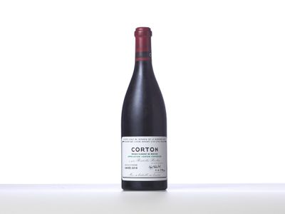 a bottle of red wine sitting on top of a table