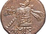 an old coin with a bird and flowers on it