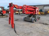 a red crane that is sitting in a parking lot