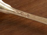 a spoon and fork sitting on a wooden table