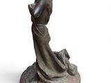 an image of a statue of a woman with a dog on her lap