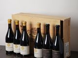 several bottles of wine are lined up in a row on a table