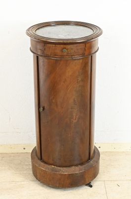 a small wooden table with a mirror on top of it