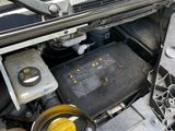 the engine compartment of a car with its hood open and the hood open