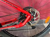 a close up of a red bike with a chain on it
