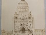 an old photo of a large building with a clock on it