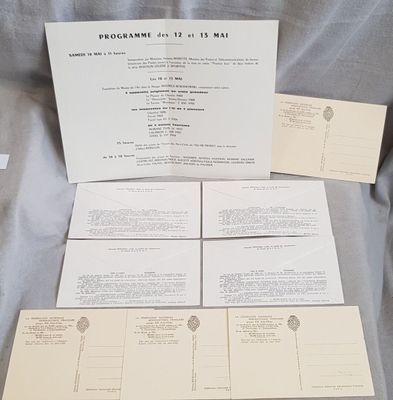 several postcards and envelopes are sitting on a sheet of paper
