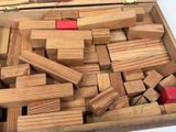 a box full of wooden blocks that are sitting on a table