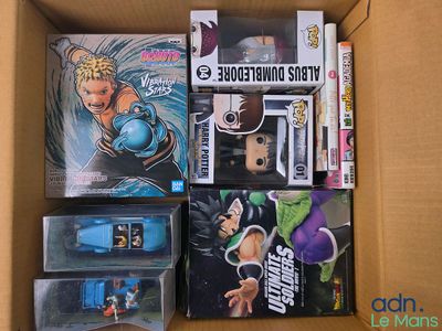 a cardboard box full of action figures and games