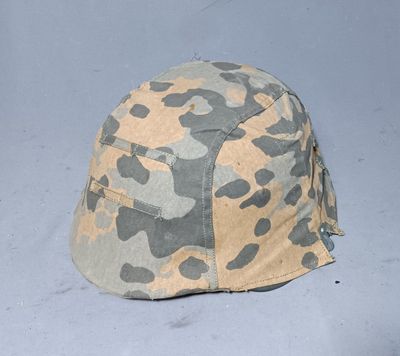 camouflage helmet on a gray surface with a white background