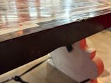 a close up of a wooden table with a metal base