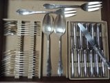 a drawer with silverware and utensils in it