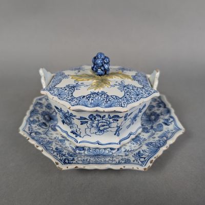 an antique blue and white bowl and saucer on a saucer