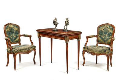 two chairs and a table with a bird figurine on top of it