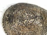a large rock with a decorative design on it