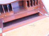 a wooden desk with a drawer on top of it