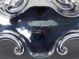 a close up of a silver vase on a table
