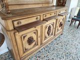 a wooden dresser with a mirror on top of it