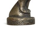 bronze statue of a woman bending over with her hands on her knees