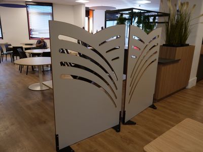 a room divider in the middle of a room with tables and chairs