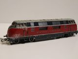 a red and black train on the tracks on a white surface