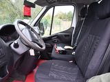 the interior of a van with black seats and a red seat cover