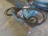 a blue machine that is on a pallet next to a blue car