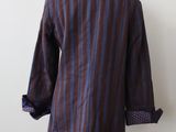 purple and blue striped jacket on a mannequin stand
