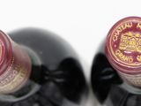 two bottles of wine sitting next to each other on a table