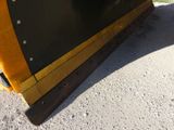 a close up of a snow plow on the ground