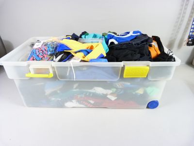 a plastic container filled with assorted items on a table