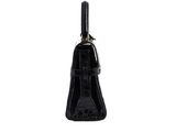 the black purse is sitting on a white surface