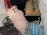 a bag of clothing that is sitting on a bed