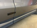 a close up of a car ' s door handle and door handle