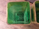 two green bowls sitting on a wooden table