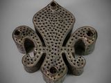 an image of a metal object with holes on it
