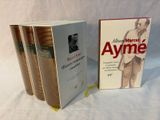 two books are sitting on a white surface next to each other