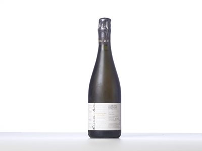 une bouteille de vin posée sur une table blanche