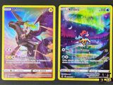 deux cartes Pokémon posées sur une surface noire, avec une bordure jaune