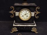 a clock that is sitting on a black table