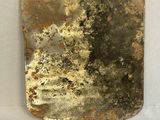 an image of a piece of rusted metal on a white surface
