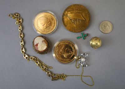 a lot of gold and silver items that are on the table