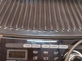 an image of a grill on a table with a remote control