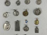 many different types of religious charms on a white surface