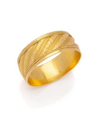a close up of a gold wedding ring on a white background