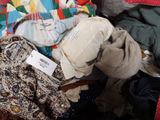 a pile of clothes that is sitting on the floor