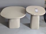 pair of round side tables with a small table top and a smaller one on each side