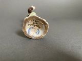 porcelain figurine of a shell with a bead on it
