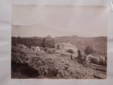 a picture of an old picture of a house on a hill