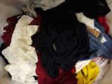 a pile of clothes in a basket on the floor